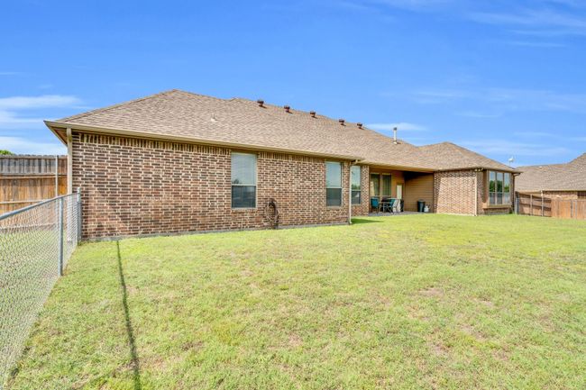 Back of house featuring roof with shingles and brick siding | Image 19