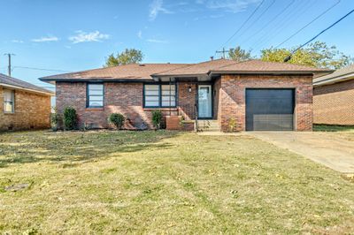 View of front facade with a garage and a front lawn | Image 2