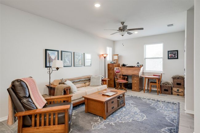 Living room with a ceiling fan, recessed lighting, wood finished floors, and visible vents | Image 20