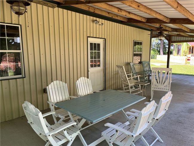 Patio beside carport, plenty of room for outdoor dining | Image 9
