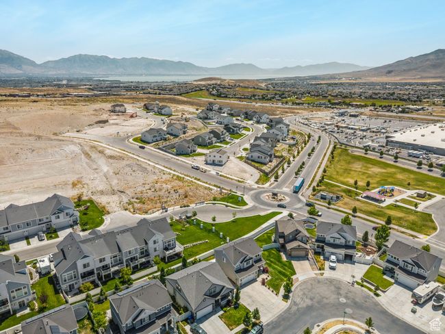 Aerial overview of property's location with a mountain backdrop and nearby suburban area | Image 36
