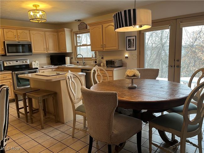 Large Kitchen with an island (stools do NOT stay) eating area and french doors leading to the backyard | Image 13