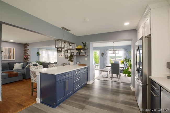 Kitchen featuring dark hardwood / wood-style flooring, stainless steel appliances, blue cabinets, decorative light fixtures, and white cabinets | Image 39