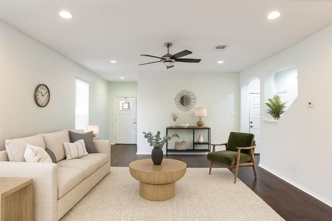 Virtually Staged Living area with wood finished floors, recessed lighting, ceiling fan, and arched walkways | Image 33