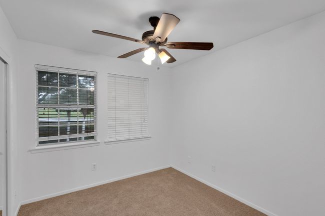 Carpeted spare room featuring baseboards and a ceiling fan | Image 19