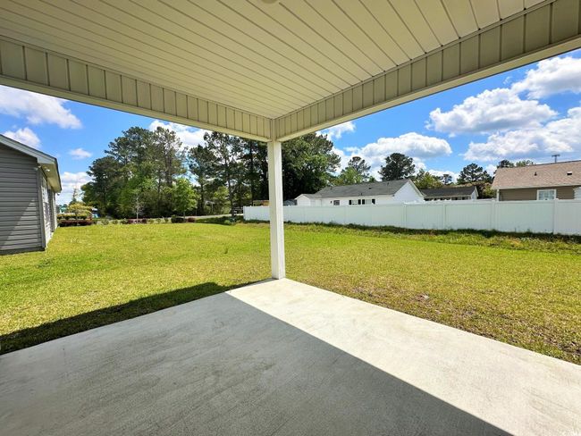 Rear view of property featuring a yard, fence, and a patio | Image 18