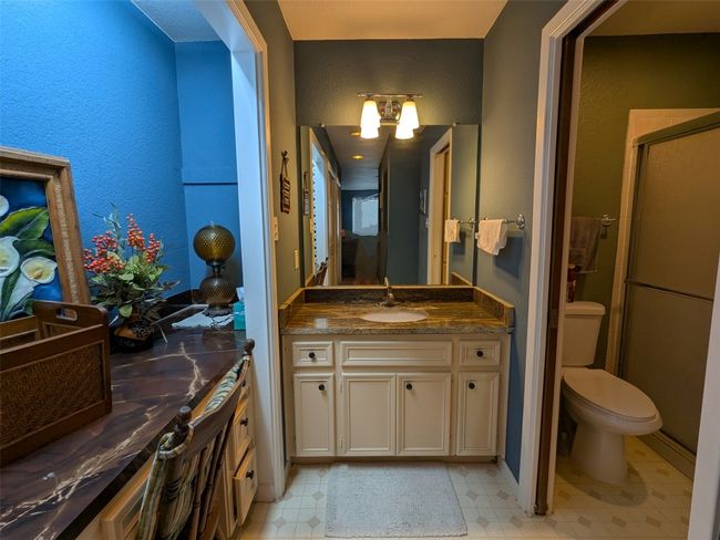 Bathroom featuring vanity, a shower stall, and tile patterned floors | Image 24