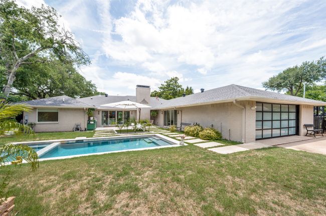 Back of property with brick siding, a chimney, a yard, and a garage | Image 31