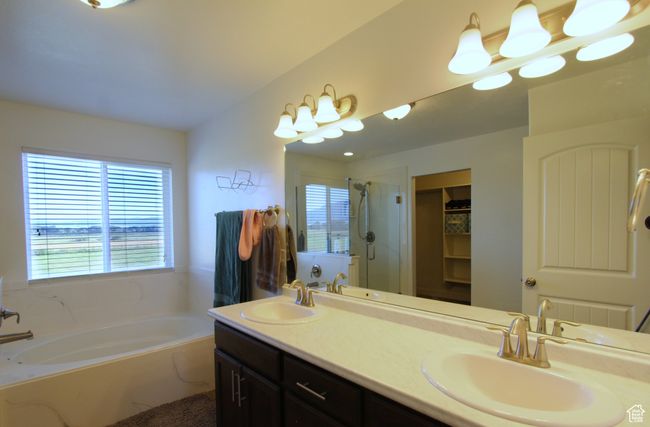 Full bath featuring a garden tub, a shower stall, double vanity, and a spacious closet | Image 20