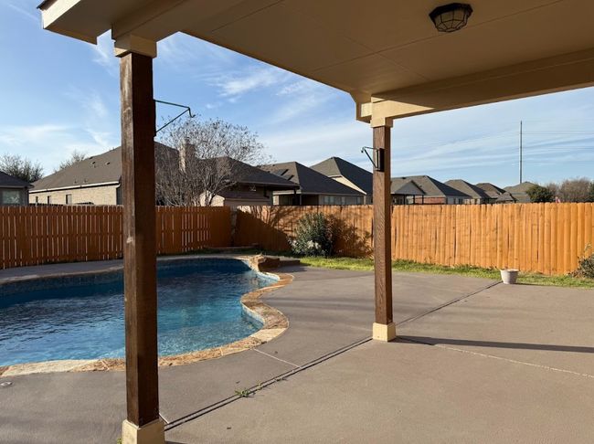 View of pool featuring a patio area, a fenced backyard to enjoy. | Image 38