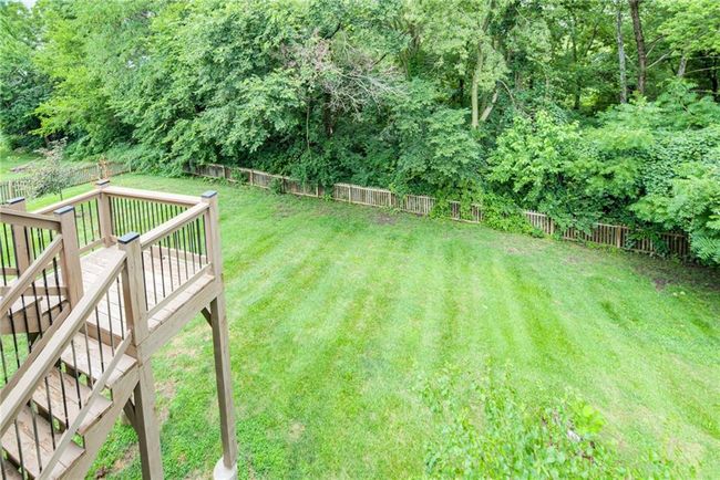 Fenced backyard with a wooden deck and stairway | Image 46