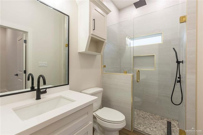 Bathroom featuring vanity, a shower with shower door, and toilet | Image 20