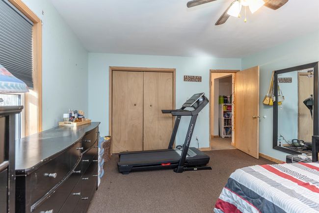 Bedroom featuring carpet flooring, a closet, and a ceiling fan | Image 36