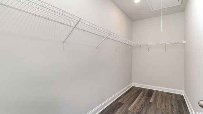 Walk in closet with dark hardwood / wood-style flooring | Image 22