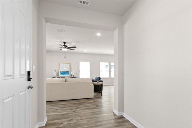 Hallway with baseboards, visible vents, wood finished floors, and recessed lighting | Image 4