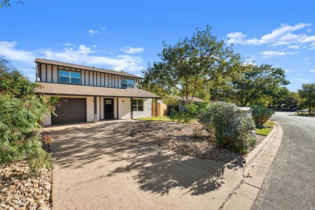 Notice the custom exterior paint with a three tone color and the long driveway which offers additional parking for you and your guests. There are beautiful native plants that enhance its natural charm. | Image 33