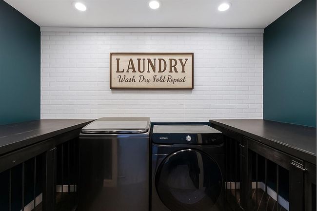 Stylish laundry room with custom cabinetry and a fun, modern farmhouse sign. | Image 36