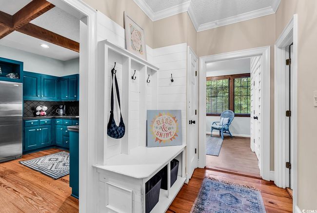 Mudroom with light wood-style floors and crown molding | Image 10