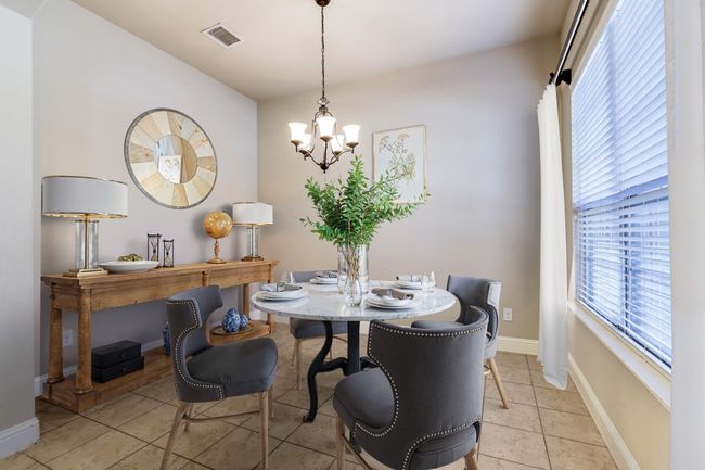 Dining room with a chandelier and light tile patterned flooring | Image 7
