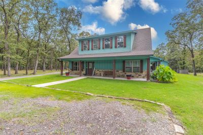 Extended covered front porch is perfect for relaxing outdoors. | Image 2