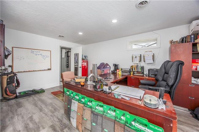 Home office featuring wood finished floors, baseboards, visible vents, recessed lighting, and a textured ceiling | Image 17