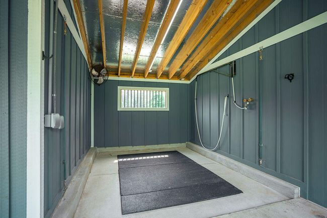 Fans, lights, recessed to back drain, overhead hose for safety, natural light, and good ventilation with back window and vaulted ceiling. | Image 64
