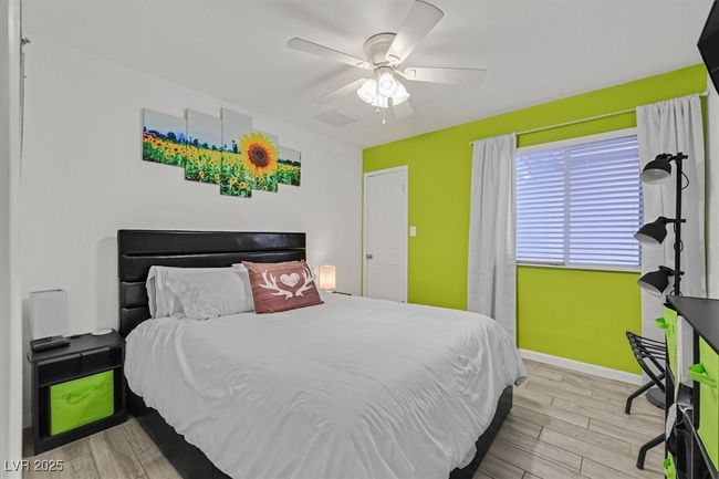 Bedroom featuring visible vents, a ceiling fan, baseboards, and wood finished floors | Image 22