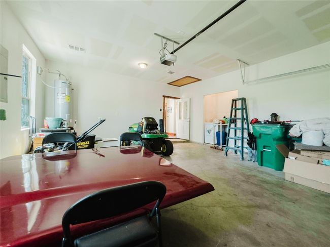 Garage with water heater and a garage door opener | Image 37