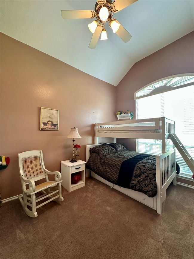 Bedroom featuring lofted ceiling, a ceiling fan, and carpet floors | Image 17