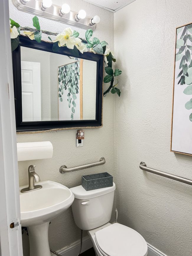Bathroom with toilet, a sink, and a textured wall | Image 20
