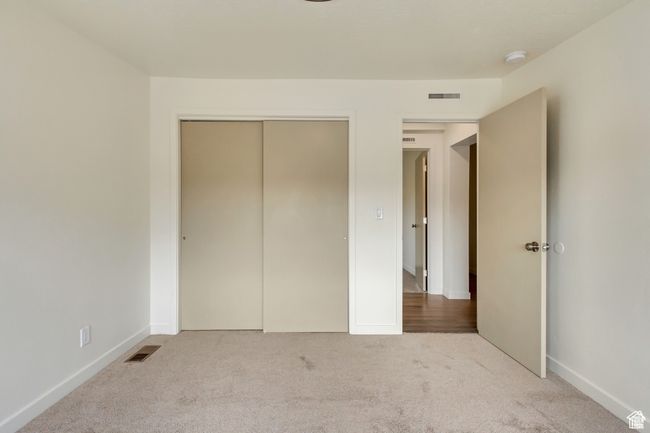Unfurnished bedroom with carpet floors, visible vents, and a closet | Image 20