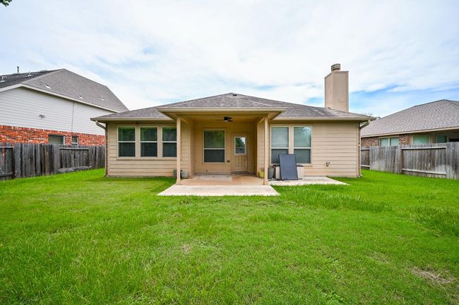 This home features a large, oversized backyard with wood fencing for privacy, no back neighbors, and plenty of room for relaxation and entertaining. | Image 30