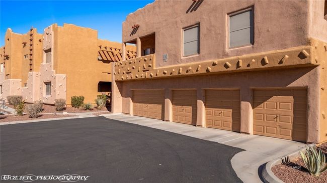 View of property featuring driveway and an attached garage | Image 54