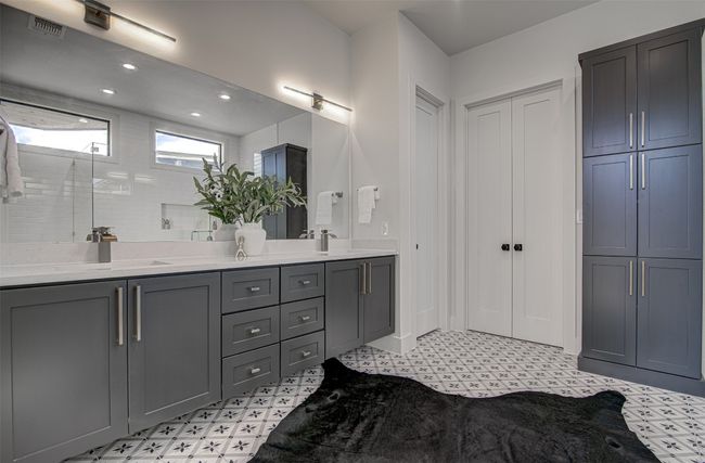 Bathroom with tile patterned floors, a closet, double vanity, and recessed lighting | Image 11