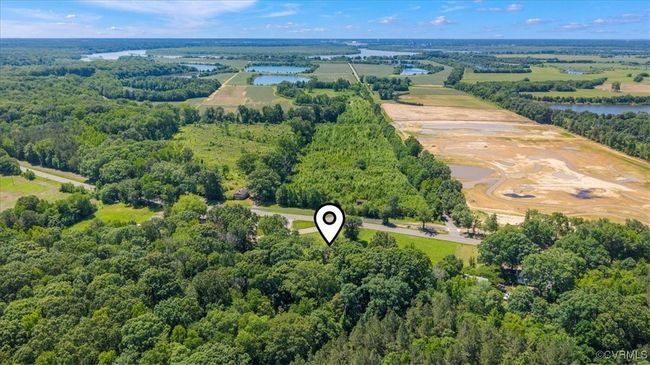 Aerial view of a heavily wooded area and a large body of water | Image 9