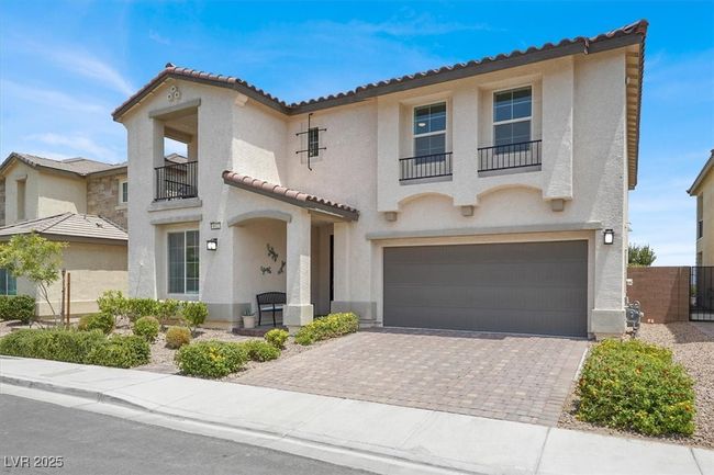 Mediterranean / spanish home featuring a balcony, driveway, stucco siding, a garage, and a tile roof | Image 6