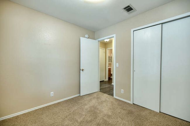 Unfurnished bedroom featuring carpet flooring, a closet, and baseboards | Image 10