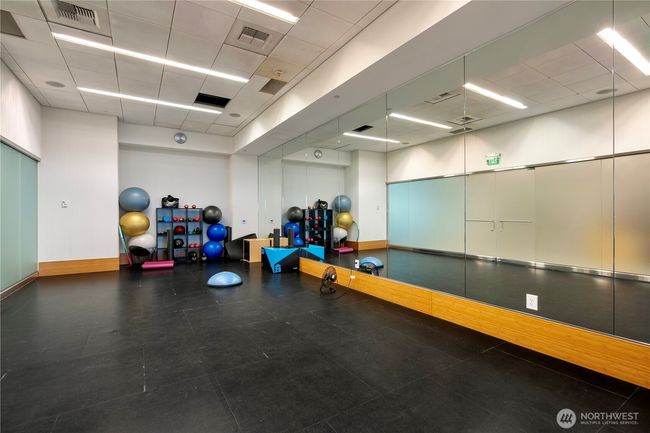 Yoga area equipped with Bosu balls and mats, offering a peaceful space for mindful exercise and stretching. | Image 21