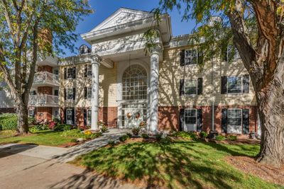 Greek revival inspired property featuring a 2 bed 2 bath unit, with an exterior patio, fireplace, reserved garage parking spot....and a whole host of new friends!! | Image 2