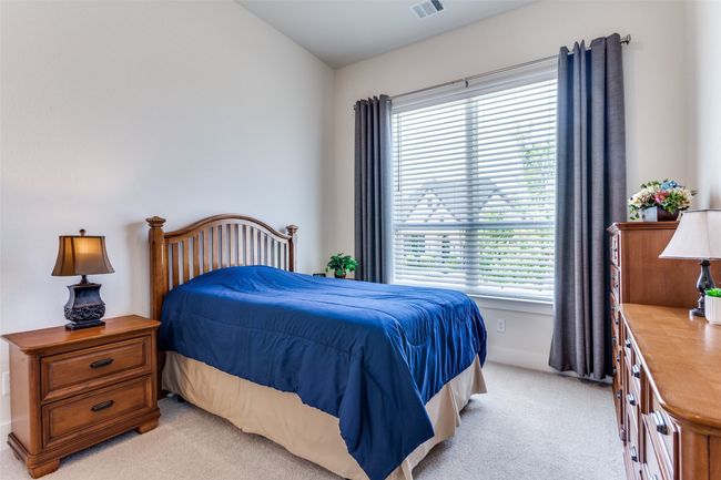 Bedroom featuring light colored carpet and multiple windows | Image 8