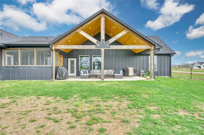 Back of property featuring outdoor lounge area, a patio area, and a lawn | Image 38