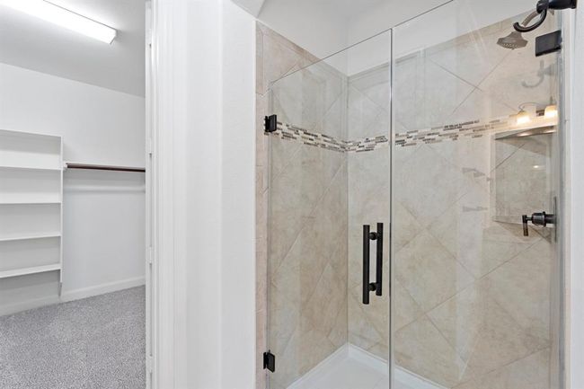 The primary bedroom also features a spacious walk-in shower and a generously sized walk-in closet, offering both comfort and convenience for your daily routine. | Image 12
