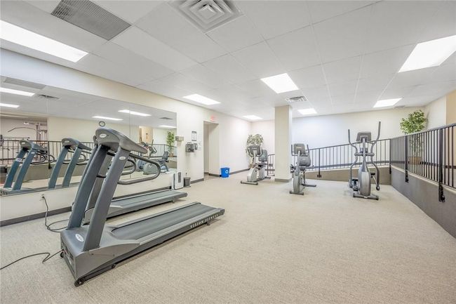 Workout area with a drop ceiling and carpet flooring | Image 14
