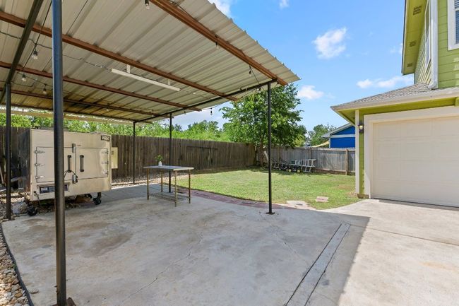 Fenced backyard featuring a patio area, a garage, and a carport | Image 36