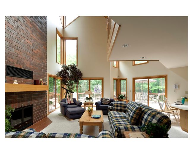 The St Anne house has lots of family space with a main level all-glass sitting area, main level formal living room with vaulted ceilings | Image 86