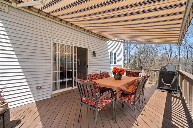 Composite deck with outdoor dining space and grilling area. Electric awning adds to your comfort. | Image 29