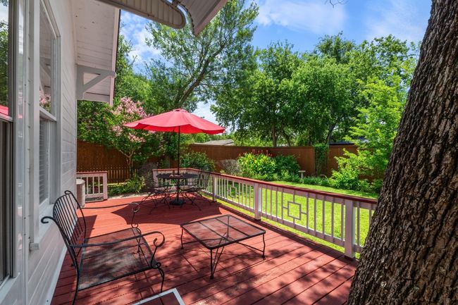 Wooden terrace with outdoor dining area and a fenced backyard | Image 21
