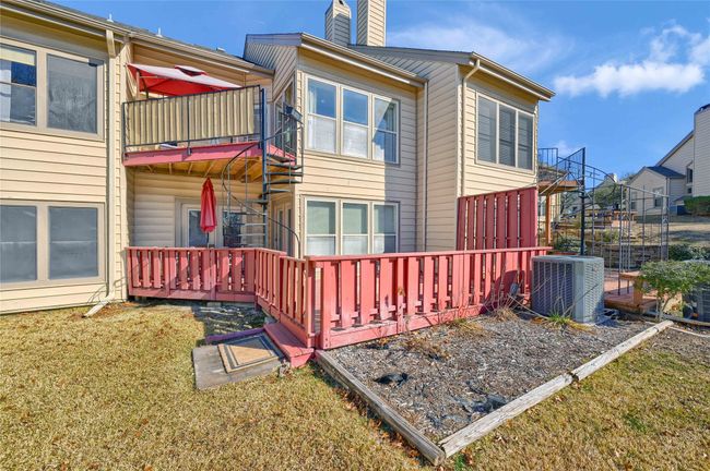 View of home's exterior with cooling unit, a chimney, and a yard | Image 28