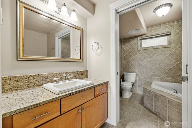 Primary bath with deep soaking tub, tiled heated floors. | Image 16