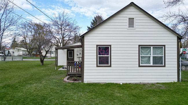 Back of house with a lawn and fence | Image 39